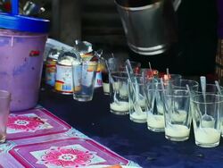 MS Shot of several glasses ready with addition of condense milk for making coffee / Luang Prabang, Laos Stock Footage