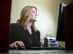Bank teller using computer in bank Stock Footage