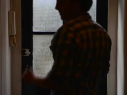 MS Shot of man leaving house with jacket and keys / London, Greater London, United Kingdom Stock Footage