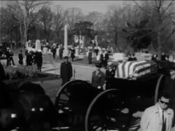 B/W 1967 PAN American flag-covered coffin on wagon driving in cemetery / crew of Apollo 1 Stock Footage