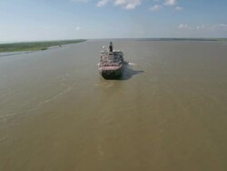 AERIAL WS Cargo ship flowing on river with helipad / New Orleans, Louisiana, United States Stock Footage