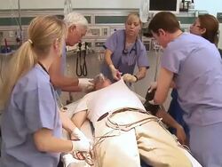 Doctors in emergency room working on unconscious patient Stock Footage