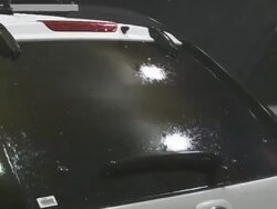 CU ZO Shot of rain and larger hail hitting rear window of vehicle at night / Lemmon, South Dakota, United States Stock Footage
