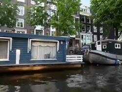 WS POV View of houseboats docked near canal / Amsterdam, The Netherlands, Holland Stock Footage