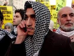 January 23, 2009 Young man talking on mobile phone during protest against Israel's attack on Gaza Strip/ Washington DC/ AUDIO Stock Footage