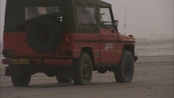 A vehicle travels along a beach. Stock Footage