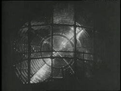 A searchlight spins in a lighthouse at night. Stock Footage