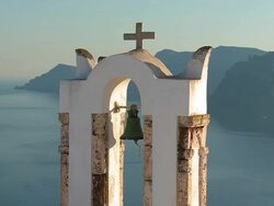 CU Shot of church bell at village Oia with Ocean / Santorini, Cyclades, Greece Stock Footage