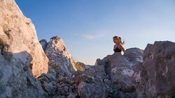 Young female runner running uphill a rocky landscape Stock Footage