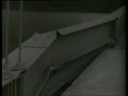 B/W 1940's close up PAN of destroyed bridge / Tacoma Narrows Bridge / SOUND Stock Footage