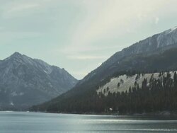 WS View of Lake Wallowa glistens on sunny winter day with snowy mountains rising steeply, From Oregons "Little Switzerland" / Joseph, Oregon, United States  Stock Footage