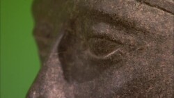 An Egyptian statue contrasts with a green background. Stock Footage