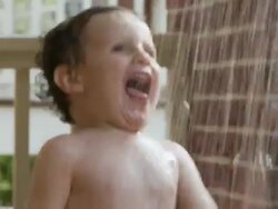 ZI, CU, Boy (2-3) playing in water on porch of house, Atlanta, Georgia, USA Stock Footage