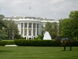 Medium Long Shot pan-left zoom-in zoom-out - The White House disintegrates behind a dinosaur in a computer-generated animation. / Washington, D.C., USA Stock Footage