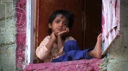 Child looking at from an open window, Karachi 1 Stock Footage