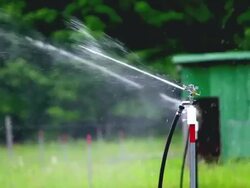 CU SLO MO Shot of irrigation sprinkler at organic farm / Chatham, Michigan, United States Stock Footage