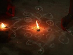 CU Hands lighting candles on dark floor, illuminating chalk drawings/ Hampi, Karnataka, India Stock Footage