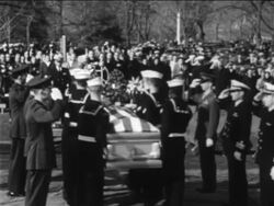 B/W 1967 PAN from Naval pallbearers carrying coffin to Lyndon Johnson in cemetery / Apollo 1 crew Stock Footage