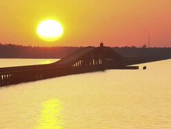 WS AERIAL View of Sunset over Colington Island shore with bridge on lake / North Carolina, United States Stock Footage