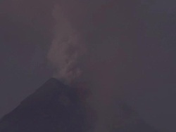 Ash rises from crater of volcano as glowing lava spills over flanks, Philippines, Dec 2009 Stock Footage