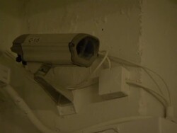 A surveillance camera hangs in a corner. Stock Footage
