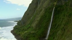 Waterfalls spill down the side of steep seacliffs on Hawaii's scenic Hamakua Coast. Stock Footage
