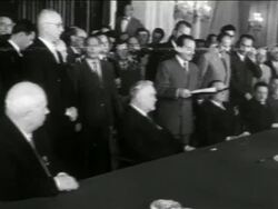 B/W 1950s Khrushchev, Nikolai Bulganin + Marshal Tito sitting at table as others stand behind them Stock Footage