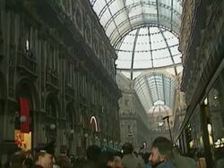 MS Gorbachev and wife walking in Milan streets, walking under arcades, big crowd waiting to see delegation, banner with Gorbachev's poster and Russian slogan AUDIO / Rome, Milan, Italy Stock Footage