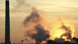 Sunset over the Iggesund paper board manufacturer in Workington, Cumbria, UK, at sunset, with wind turbines. The plant is powered by a biofuel power station, on site. Stock Footage