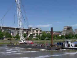 WS Crane lifted with bridge segment moving ahead with Mosel river, deconstruction of bridge / Wellen, Rhineland Palatinate, Germany Stock Footage