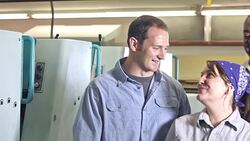 Three workers in manufacturing plant talking, laughing Stock Footage
