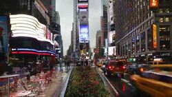 Pedestrians and traffic move through Times Square on a rainy day. Stock Footage