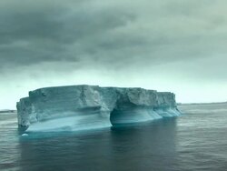 lonely iceberg with ominous sky Stock Footage