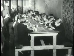 Children hungrily gobble food in a soup kitchen. News Clip