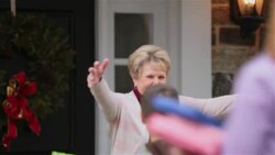 Excited grandmother opens door and greets grandchildren and daughter with hugs Stock Footage