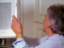 low angle PAN senior woman putting food in microwave + heating Stock Footage