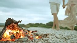 Couple walking and holding hands on the beach Stock Footage
