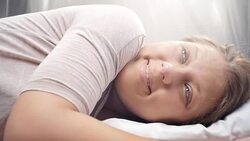 People waking up - Young woman opens her eyes on a sunny morning Stock Footage