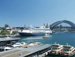 The Ocean Liner "Amsterdam" at the Ocean Terminal with Harbour Bridge and Ferry Terminal, Sydney, New South Wales, Australia Stock Footage