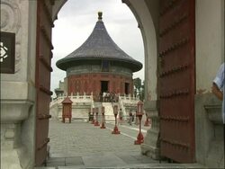MS through archway to Imperial Vault of Heaven in courtyard of Temple of Heaven, Beijing, China Stock Footage