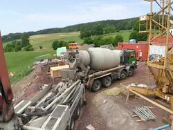 WS HA View of concrete mixture truck at house construction, building site / Hermeskeil, Rhineland Palatinate, Germany Stock Footage