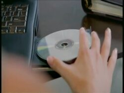 CU hand inserting CD into disc drive Stock Footage