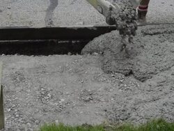 MS Shot of Workmen spreading and leveling concrete being poured for sidewalk / Valparaiso, Indiana, United States Stock Footage