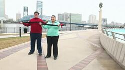 Overweight couple exercising with resistance bands Stock Footage