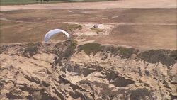 Paragliders take off from a cliff near San Diego. Stock Footage