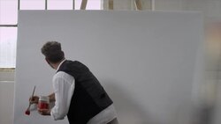 Artist starts painting on canvas Stock Footage