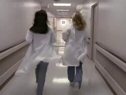 Two Female doctors running in hall Stock Footage