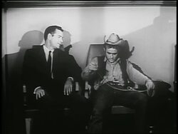 B/W 1955 Gig Young + James Dean in cowboy hat holding rope stand up from chairs / PSA Stock Footage