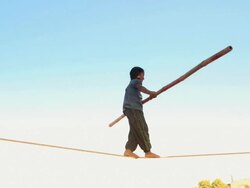 Boy walking on tightrope, Pushkar, Rajasthan, India Stock Footage