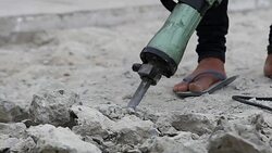 Close up Worker man drilling cement concrete road for put the plumbing Stock Footage